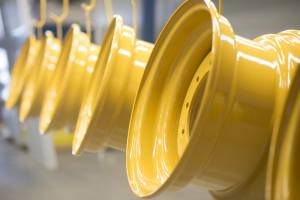 yellow powder coated rims hanging in the warehouse