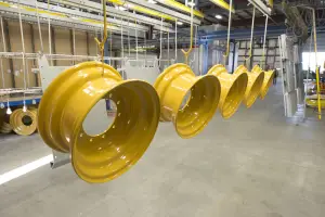 yellow powder coated rims hanging in the warehouse