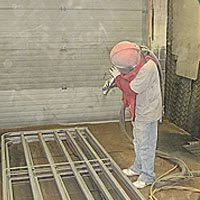 Media Blasting Icon showing a man blasting items